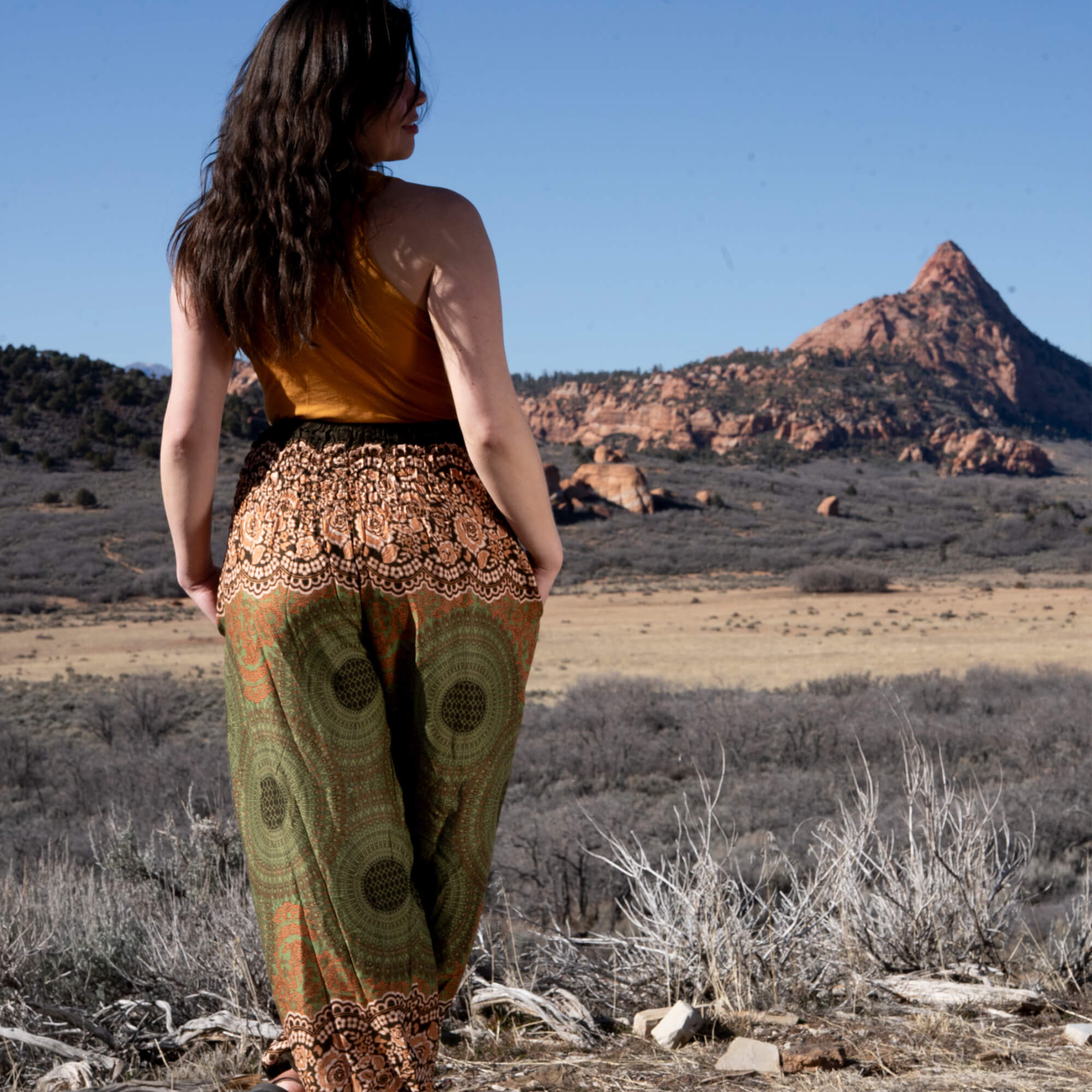 Woman wearing grounded Charlee Girl Earth Collection pieces in natural tones outdoors in warm earthy light