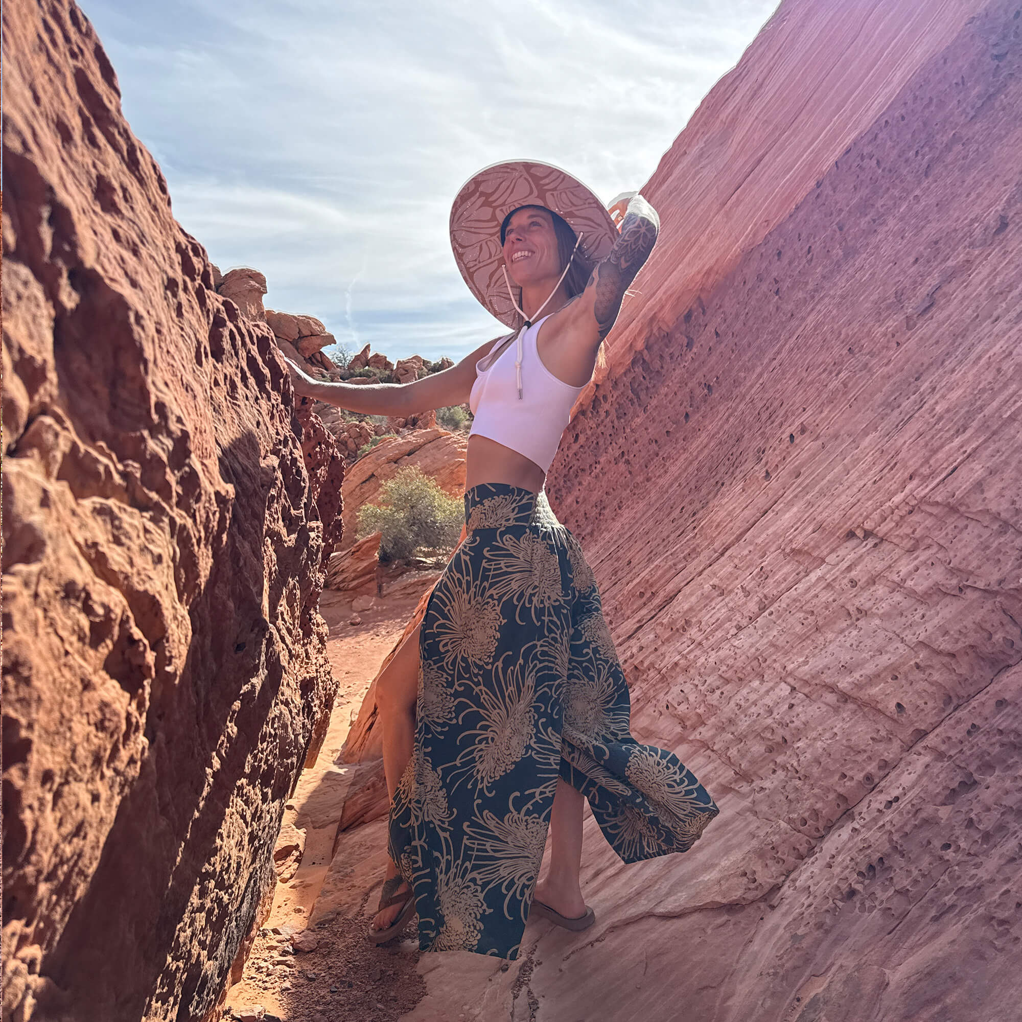 Karlene Linxweiler founder of Charlee Girl outdoors in natural light wearing Charlee Girl clothing and straw hat