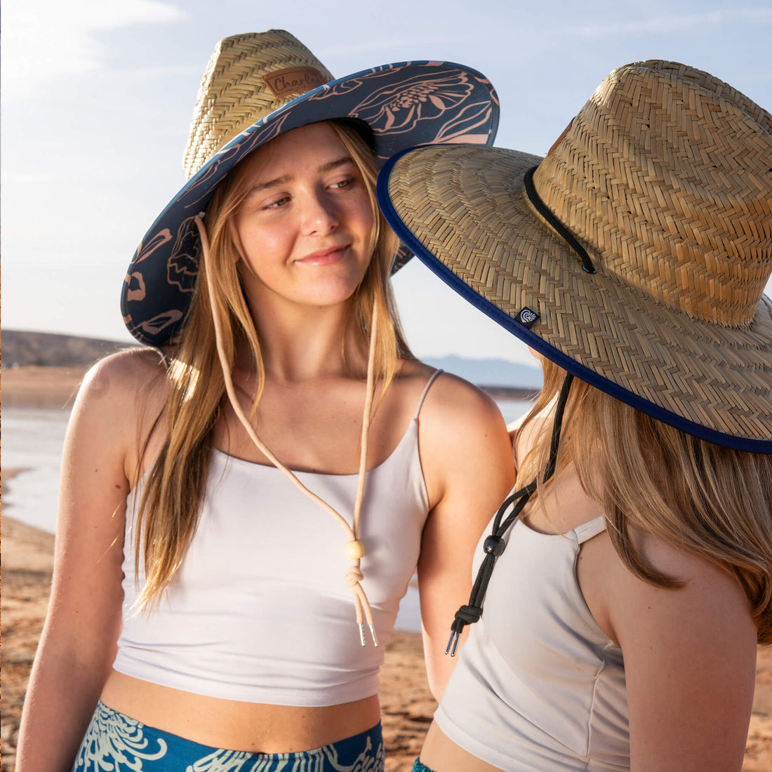 Collection of Charlee Girl natural straw sun hats named after inspiring women, showing colorful patterned under-brims