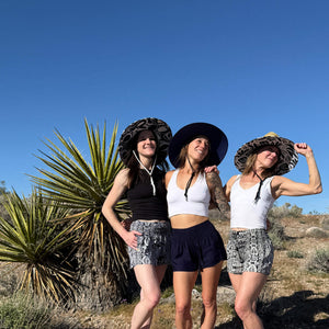 Three women in Ashley, JoJo, and Jessica straw hats with printed shorts — boho straw sun hat group