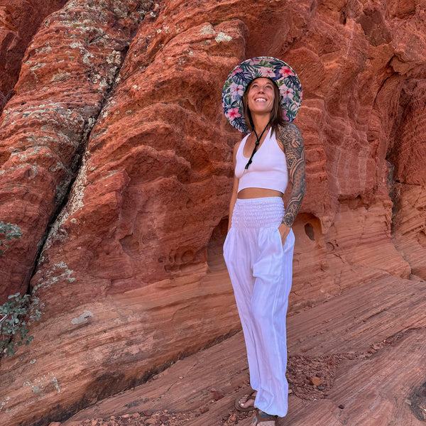 Karlene wearing Moonlight White harem pants with Lifeguard Sun Hat — white boho pants styled