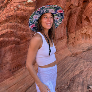 Back view of The Tenley Hollow Mat hat with white harem pants — tropical hibiscus lifeguard straw hat