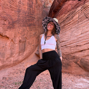 Karlene in The Jessica Hollow Mat hat with obsidian harem pants — lifeguard brim boho straw sun hat
