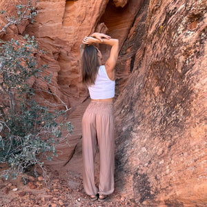 Karlene wearing sandstone harem pants — tan boho harem pants women front view