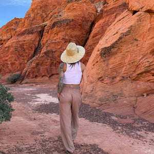 Sandstone harem pants back view styled with Lifeguard hat — boho pants outfit back