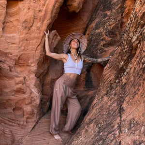 Karlene wearing The Charlee Hollow Mat hat with sandstone harem pants — wide brim straw sun hat