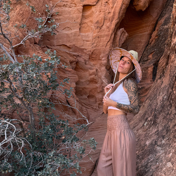 Sandstone harem pants with Charlee sun hat — neutral harem pants lifestyle look
