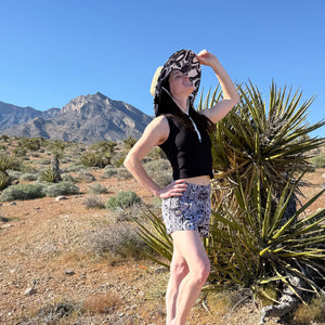 Lauren wearing The Ashley straw sun hat with Ocean Wave shorts — navy circle under-brim boho hat