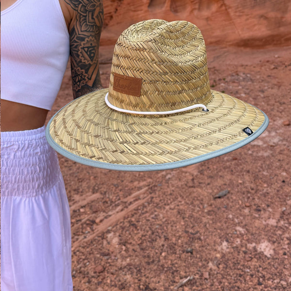 Karlene in The Sage Hollow Mat hat outdoors with white harem pants — sage green straw sun hat