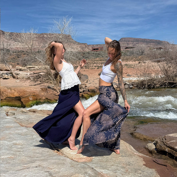 Two women in ocean wave palazzo pants — navy floral wide leg boho pants group shot