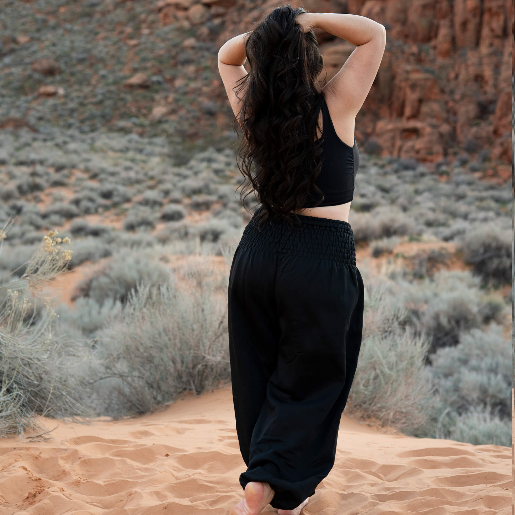 Back view of Obsidian Black harem pants — black flowy pants women