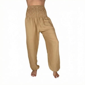Woman wearing cream harem pants — beige flowy pants
