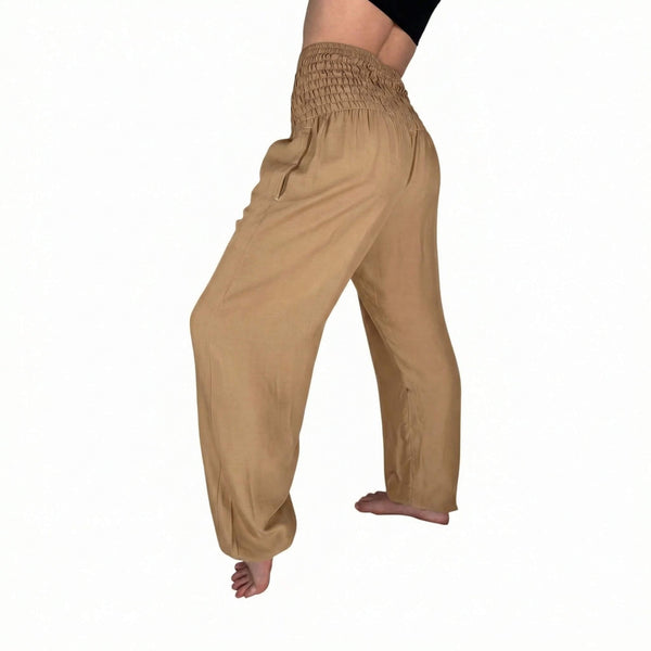 Side drape view of Creme harem pants — beige flowy pants styled