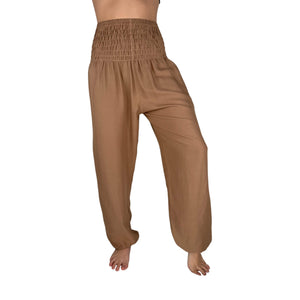 Woman wearing sandstone harem pants — tan boho pants